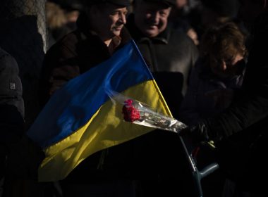 People attend a ceremony to mark the anniversary of the withdrawal of Soviet troops from Afghanistan in the city of Kyiv, Ukraine, Tuesday, Feb. 15, 2022. Russia says that some units participating in military exercises will begin returning to their bases. That adds to glimmers of hope that the Kremlin may not be planning to invade Ukraine imminently. (AP Photo/Emilio Morenatti)