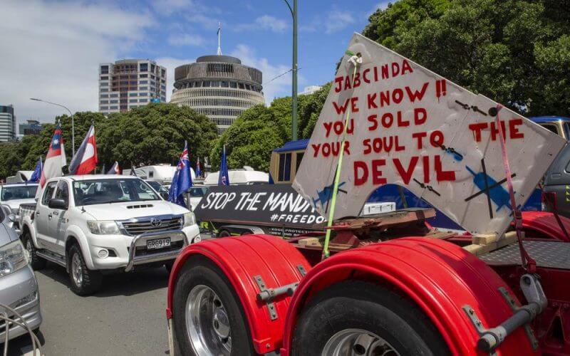 A convoy of vehicles block a road near New Zealand's Parliament in Wellington Tuesday, Feb. 8, 2022. Hundreds of people protesting vaccine and mask mandates drove in convoy to New Zealand's capital on Tuesday and converged outside Parliament as lawmakers reconvened after a summer break. (Mark Mitchell/New Zealand Herald via AP)