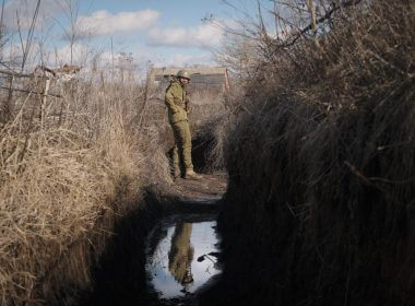 A Ukrainian serviceman pauses while walking to a frontline position outside Popasna, in the Luhansk region, eastern Ukraine, Sunday, Feb. 20, 2022. Russia extended military drills near Ukraine's northern borders Sunday amid increased fears that two days of sustained shelling along the contact line between soldiers and Russia-backed separatists in eastern Ukraine could spark an invasion. Ukraine's president appealed for a cease-fire. (AP Photo/Vadim Ghirda)