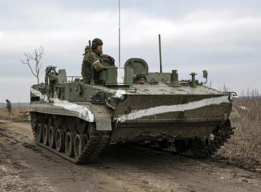 An armored vehicle rolls outside Mykolaivka, Donetsk region, the territory controlled by pro-Russian militants, in eastern Ukraine, Sunday, Feb. 27, 2022. Fighting also raged in two eastern territories controlled by pro-Russia separatists. (AP Photo)