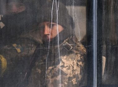 Members of Ukrainian forces looks on from a public transport bus in downtown Kyiv, on Feb. 27. Photo: Aris Messinis / AFP via Getty Images