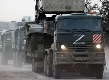 A column of Russian army trucks moves across the town of Armyansk, northern Crimea, on Thursday. Photo: Sergei Malgavko/TASS via Getty Images