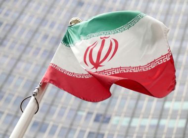 The Iranian flag flutters in front the International Atomic Energy Agency (IAEA) headquarters in Vienna, Austria