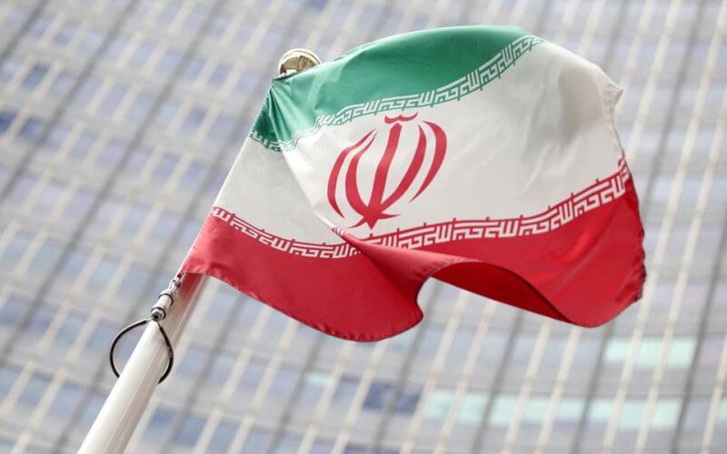 The Iranian flag flutters in front the International Atomic Energy Agency (IAEA) headquarters in Vienna, Austria