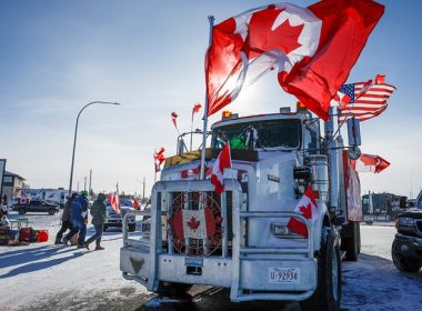 The last truck blocking the southbound lane moves after a breakthrough resolved the impasse where anti-COVID-19 vaccine mandate demonstrators blocked the highway at the busy U.S. border crossing in Coutts, Alberta, Wednesday, Feb. 2, 2022. (Jeff McIntosh /The Canadian Press via AP)