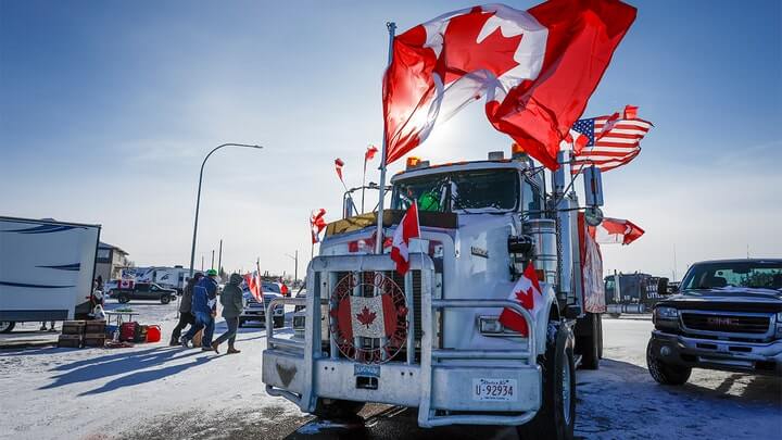The last truck blocking the southbound lane moves after a breakthrough resolved the impasse where anti-COVID-19 vaccine mandate demonstrators blocked the highway at the busy U.S. border crossing in Coutts, Alberta, Wednesday, Feb. 2, 2022. (Jeff McIntosh /The Canadian Press via AP)