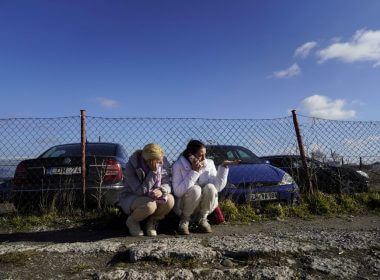 Two women react after crossing the Polish border, as they flee violence in Ukraine, in Medyka, Poland, February 24, 2022. REUTERS/Bryan Woolston