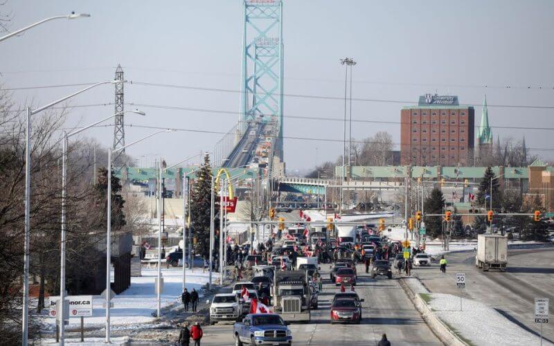 Vehicles block the route leading from the Ambassador Bridge, linking Detroit and Windsor, as truckers and their supporters continue to protest against the coronavirus disease (COVID-19) vaccine mandates, in Windsor, Ontario, Canada February 8, 2022. REUTERS/Carlos Osorio