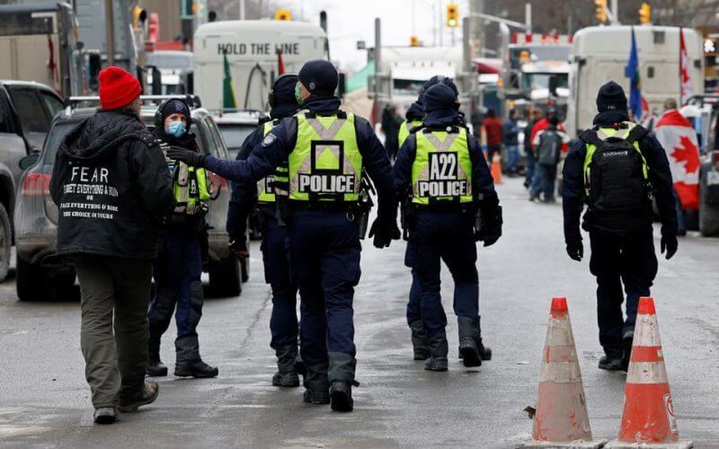 Police officers patrol downtown streets as truckers and supporters continue to protest coronavirus disease (COVID-19) vaccine mandates, in Ottawa, Ontario, Canada, February 16, 2022. REUTERS/Blair Gable