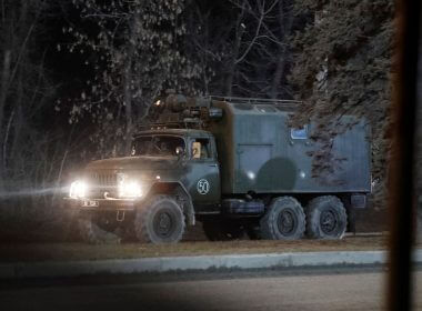 A military vehicle is seen on a street on the outskirts of the separatist-controlled city of Donetsk, Ukraine February 24, 2022. REUTERS/Alexander Ermochenko