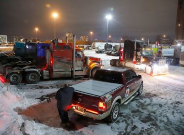 Trucks sit in a staging area east of downtown after police raided the truckers' stockpile of fuel