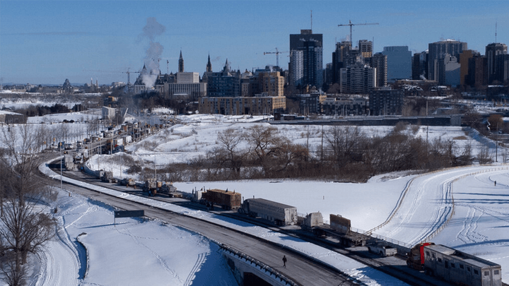 Vehicles of the protest convoy are seen parked on the Sir John A. Macdonald parkway leading in to downtown Ottawa on Sunday, Jan. 30, 2022. (Adrian Wyld/The Canadian Press via AP / AP Newsroom)