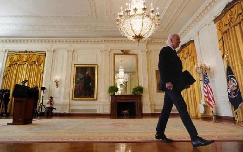 U.S. President Joe Biden walks from the rostrum after speaking about the situation concerning Russia and Ukraine, at the White House in Washington, U.S., February 22, 2022. REUTERS/Kevin Lamarque 