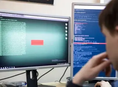 FILE - A cybersecurity worker develops computer code in an office in Moscow, Russia, Oct. 25, 2017. The U.S. and allies are bracing for the possibility that a Russian invasion of Ukraine would have a ripple effect in cyberspace.
