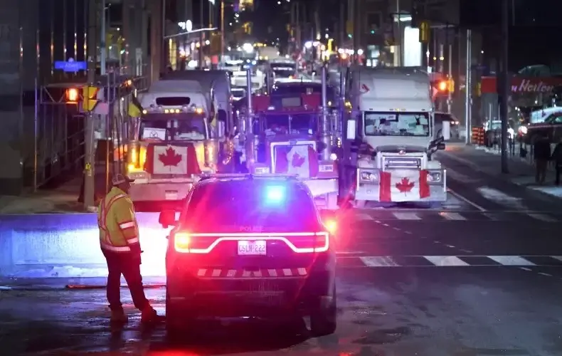 A police vehicle blocks a downtown street to prevent trucks from joining a blockade of truckers protesting vaccine mandates near the Parliament Buildings on February 15, 2022 in Ottawa, Ontario, Canada Prime Minister Justin Trudeau has invoked the Emergencies Act for the first time in Canada's history to try to put an end to the blockade which is now in its third week. The CEO of a towing company in Ottawa, Canada said his business will not comply with Trudeau's order. (Photo by Scott Olson/Getty Images) SCOTT OLSON/GETTY IMAGES