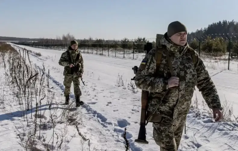 Members of the Ukrainian Border Guard patrol along the Ukrainian border fence at the Three Sisters border crossing between, Ukraine, Russia and Belarus on February 14, 2022 in Senkivka, Ukraine. Russia said on Tuesday that is pulling back some of its troops from near the border with Ukraine, but Kyiv called its bluff, asking to see evidence that it has withdrawn the soldiers. CHRIS MCGRATH/GETTY