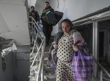 An injured pregnant woman walks downstairs in the damaged by shelling maternity hospital in Mariupol, Ukraine, Wednesday, March 9, 2022. A Russian attack has severely damaged a maternity hospital in the besieged port city of Mariupol, Ukrainian officials say. (AP Photo/Evgeniy Maloletka)