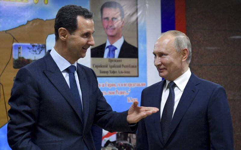 Syrian President Bashar Assad, left, gestures while speaking to Russian President Vladimir Putin during their meeting in Damascus, Syria, Tuesday, Jan. 7, 2020. With its war on Ukraine now in its third week, Putin on Friday, March 11, 2022, approved bringing in volunteer fighters from the Middle East into the conflict. (Alexei Druzhinin, Sputnik, Kremlin Pool Photo via AP, File)