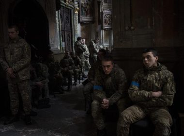 Military cadets attend a funeral ceremony for four of the Ukrainian military servicemen, who were killed during an airstrike in a military base in Yarokiv, in a church in Lviv, Ukraine, Tuesday, March 15, 2022. At least 35 people were killed and many wounded in Sunday's Russian missile strike on a military training base near Ukraine's western border with NATO member Poland. (AP Photo/Bernat Armangue)