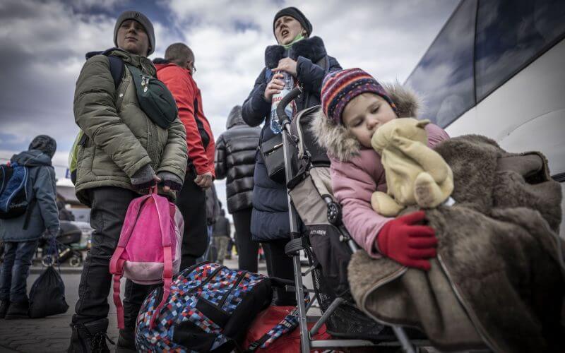 Ukrainian refugees waiting outside a bus taking them over the border into neighboring Poland on Feb. 25. Photo: Michael Kappeler/picture alliance via Getty Images