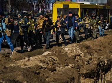 Volunteers for Territorial Defense Units arrive and march past trenches dug to defend their positions against the incoming Russian invasion, in Kyiv, Ukraine on Feb. 28. Photo: Marcus Yam/ LOS ANGELES TIMES