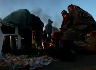 Refugees brave the cold in a frozen field after they fled from Ukraine because of the Russian invasion at the border checkpoint in Medyka, Poland, March 1, 2022.