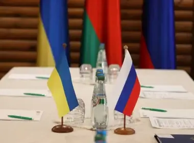 Ukrainian and Russian flags are seen on a table before the talks between officials of the two countries in the Brest region, Belarus March 3, 2022