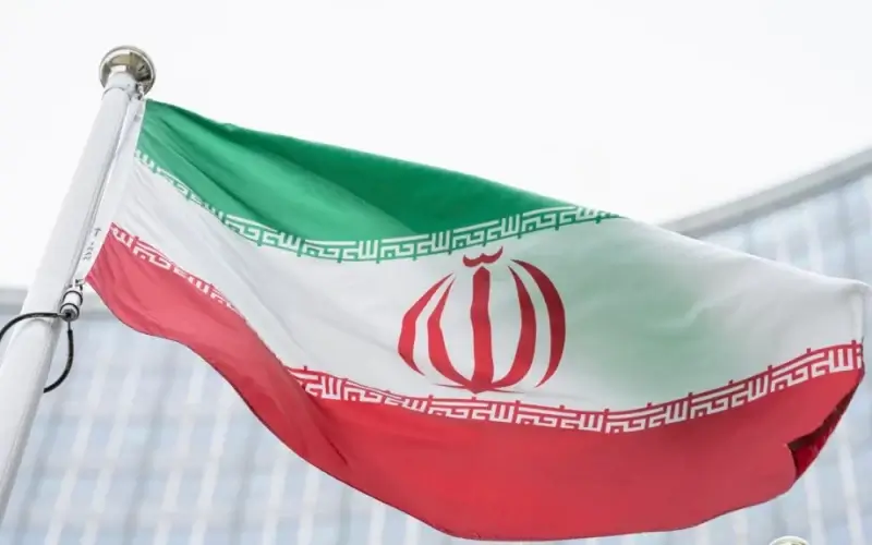 FILE - The flag of Iran waves in front of the the International Center building with the headquarters of the International Atomic Energy Agency, IAEA, in Vienna, May 24, 2021.