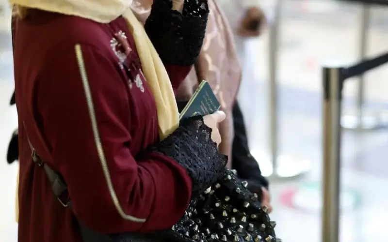 An Afghan woman holds her passport at the international airport in Kabul, Afghanistan, September 9, 2021. WANA (West Asia News Agency) via REUTERS
