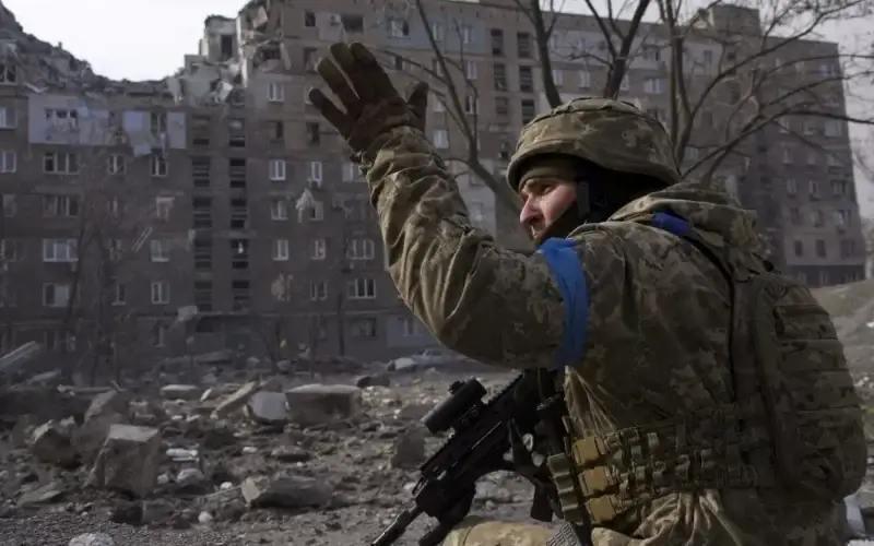 A Ukrainian service member guards his position in Mariupol, Ukraine, Saturday, March 12, 2022. (Associated Press)