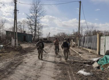 Ukranian servicemen walk through the village of Lukyanivka outside Kyiv, as Russia's invasion of Ukraine continues,