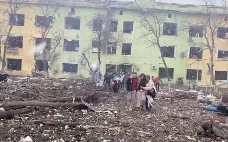 A person is carried out after the destruction of Mariupol children's hospital as Russia's invasion of Ukraine continues, in Mariupol, Ukraine, March 9, 2022 in this still image from a handout video obtained by Reuters. Ukraine Military/Handout via REUTERS