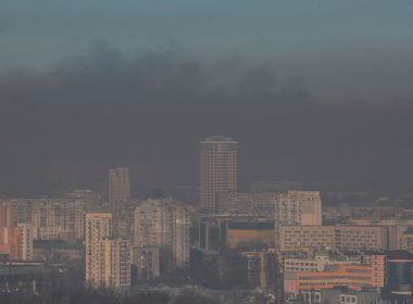 Residential buildings are seen through smoke from fires after shelling on the outskirts of the capital, in Kyiv, Ukraine March 23, 2022. REUTERS/Gleb Garanich