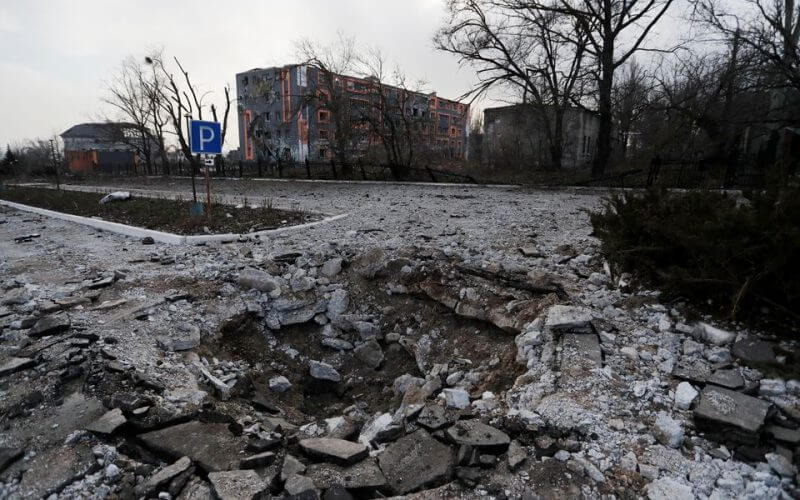 A shell crater is seen in the street during Ukraine-Russia conflict in the besieged southern port of Mariupol, Ukraine March 27, 2022. REUTERS/Alexander Ermochenko