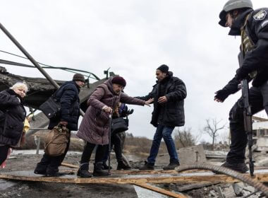 Local residents cross a destroyed bridge as they evacuate from the town of Irpin, after days of heavy shelling on the only escape route used by locals, while Russian troops advance towards the capital, in Irpin, near Kyiv, Ukraine March 7, 2022. REUTERS/Carlos Barria