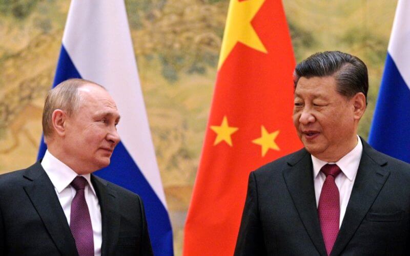 Alexei Druzhinin, Sputnik, Kremlin Pool Photo via AP File photo: Chinese President Xi Jinping, right, and Russian President Vladimir Putin talk to each other during their meeting in Beijing, China on Feb. 4, 2022.