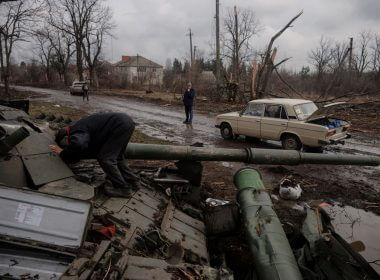 A local man looks into a Russian tank left behind after Ukrainian forces expelled Russian soldiers from the town of Trostyanets which they had occupied at the beginning of its war with Ukraine, March 30, 2022. REUTERS/Thomas Peter