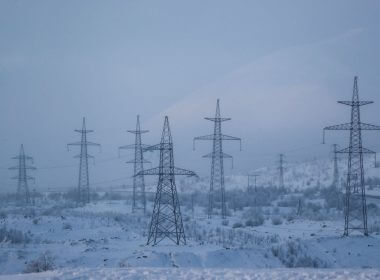 Power transmission lines are seen on a frosty day outside the town