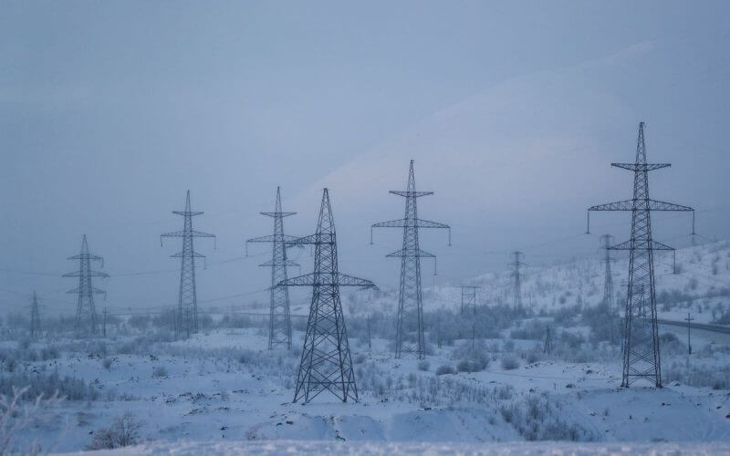 Power transmission lines are seen on a frosty day outside the town