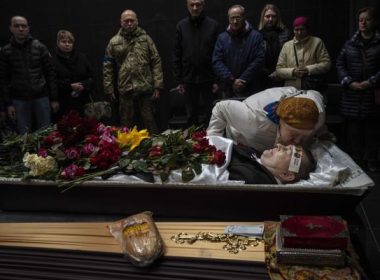 Natalya kisses her brother Sergiy Muravyts'kyi, 61, who was killed by Russian soldiers in the village of Mriya, which means Dream, in Ukrainian, during a ceremony before his cremation in Baikove cemetery, Kyiv, Ukraine, Thursday, March 24, 2022. (AP Photo/Rodrigo Abd)