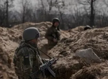 Ukrainian servicemen stand in trenches at a position north of the capital Kyiv, Ukraine, March 29, 2022.