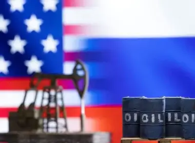 Models of oil barrels and a pump jack are seen in front of displayed U.S. and Russia flag colours in this illustration taken March 8, 2022. REUTERS/Dado Ruvic/Illustration