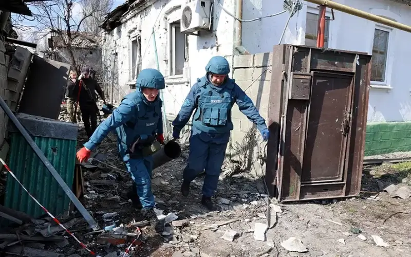 Emergency workers carry a fragment of a missile after shelling in a street in Donetsk, in territory under the government of the Donetsk People’s Republic, in eastern Ukraine, Tuesday, April 5, 2022. (AP Photo/Alexei Alexandrov)