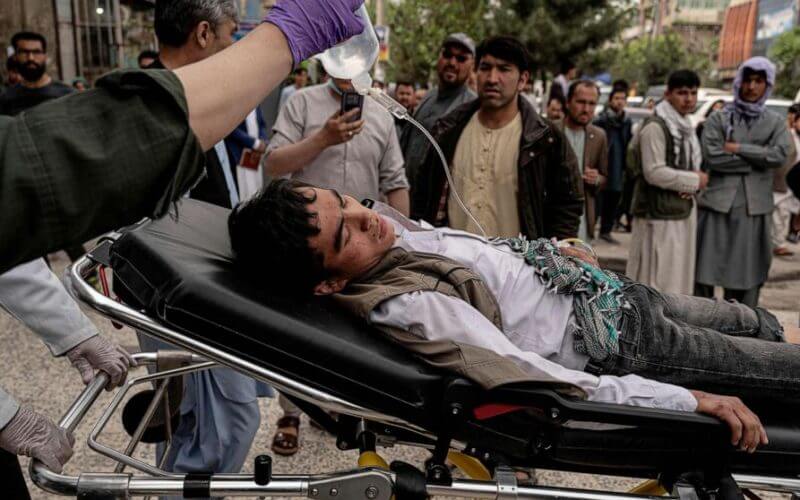Medical staff move a wounded youth by stretcher outside a hospital in Kabul, April 19, 2022, after two bomb blasts rocked a boys' school in a Shiite Hazara neighborhood killing several. Wakil Kohsar/AFP via Getty Images