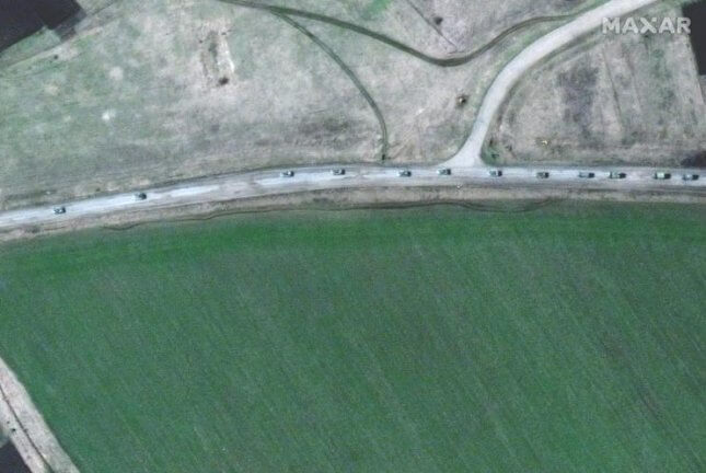 A handout satellite image made available by Maxar Technologies shows a convoy of armored military vehicles and trucks that extends for at least eight miles moving south through the Ukrainian town of Velykyi Burluk on Friday. Photo courtesy Maxar Technologies