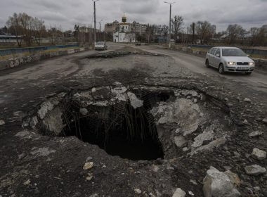 Cars drive near a damaged bridge following a Russian attack in the previous weeks in the town of Makarov, Kyiv region, Ukraine, on Sunday, April 10, 2022. (AP Photo/Petros Giannakouris)