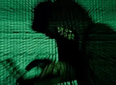 A man holds a laptop computer as cyber code is projected on him in this illustration picture taken on May 13, 2017. (photo credit: REUTERS/KACPER PEMPEL/FILE PHOTO)