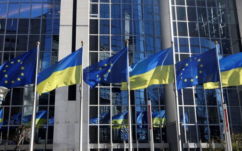The flags of the European Union and Ukraine flutter outside the European Parliament building, in Brussels, Belgium, February 28, 2022. REUTERS/Yves Herman/File Photo