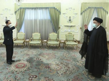 In this photo released by the official website of the office of the Iranian Presidency, President Ebrahim Raisi, right, and China's minister of national defense Gen. Wei Fenghe greet at the start of their meeting at the presidency office in Tehran, Iran, Wednesday, April 27, 2022. (Iranian Presidency Office via AP)