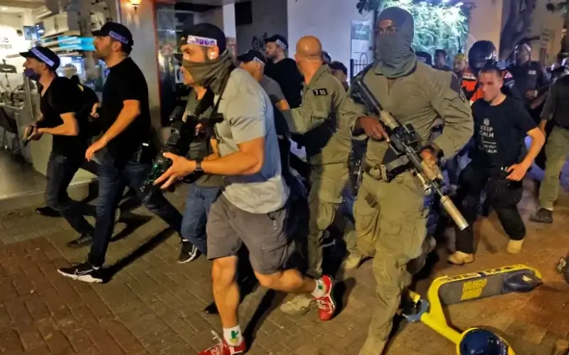 Large police forces race down Dizengoff Street in Tel Aviv searching for the gunman who killed two people and wounded at least a dozen more on April 7, 2022 (photo credit: JACK GUEZ/AFP VIA GETTY IMAGES)